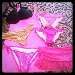 Lot of bikini bottoms, top and pink dress